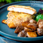 Cut open chicken parmo cheese topped breaded chicken escalope served with fried potatoes featuring a title overlay.