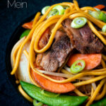 Close up hoisin duck chow mein stir fry with noodles, carrots and sugar snap peas featuring a title overlay.