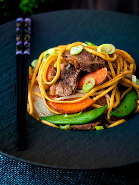 Hoisin duck chow mein stir fry with noodles, carrots and sugar snap peas.