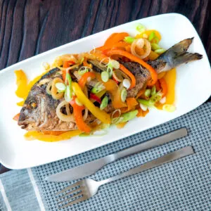 Jamaican influenced escovitch fish with whole sea bream and "pickled" peppers and onions.