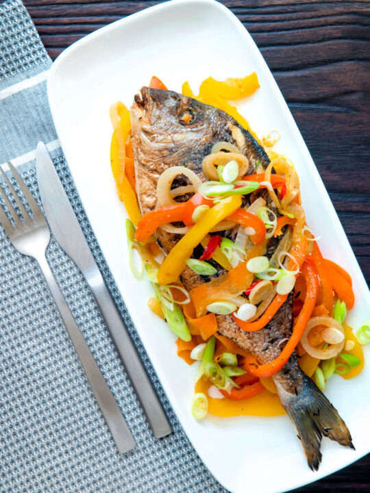Overhead Jamaican influenced escovitch fish with sea bream and "pickled" peppers and onions.