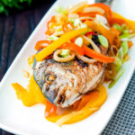 Jamaican influenced escovitch fish with sea bream and "pickled" peppers and onions featuring a title overlay.