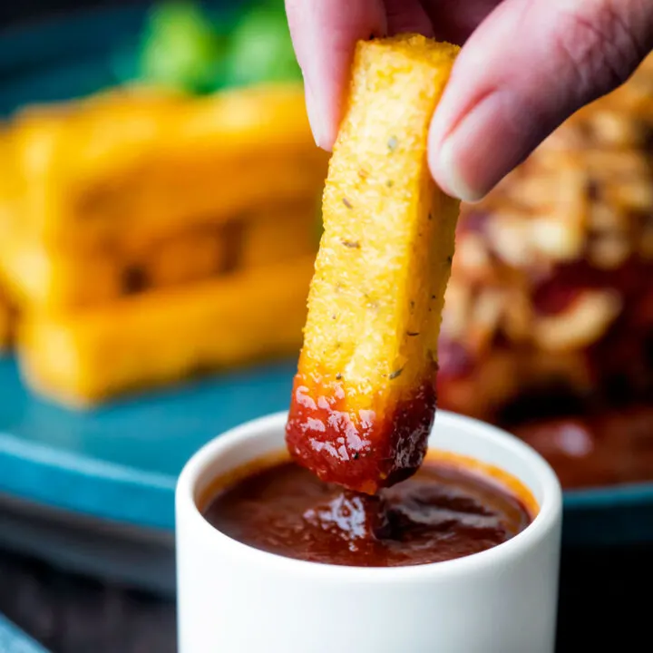 Crispy fried polenta chips dipped into BBQ sauce.