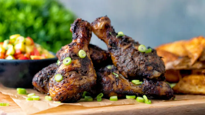 Jamaican jerk chicken drummers served with mango salsa and potato wedges.