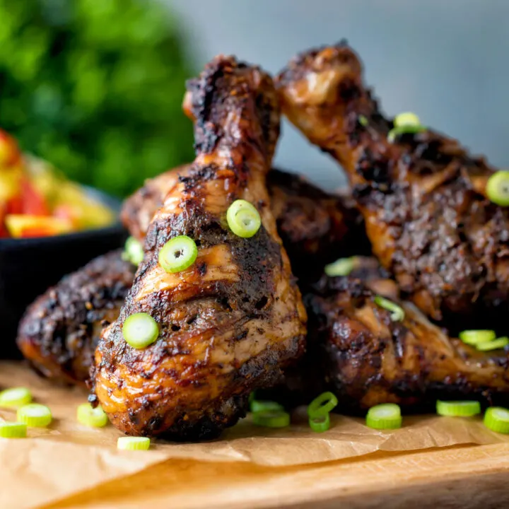 Jamaican jerk chicken drumsticks served with mango salsa.