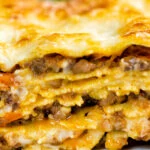 Close up Lasagna Bolognese, showing layers of ragu, pasta and bechamel sauce.