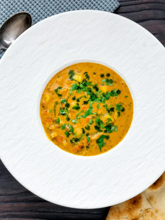 Overhead chicken mulligatawny soup with coconut milk.