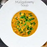 Overhead chicken mulligatawny soup with coconut milk featuring a title overlay.