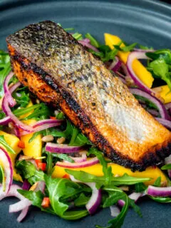 Pan fried jerk salmon fillet served with mango and rockets salad.