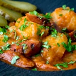 Close up Hungarian paprikas krumpli or paprika potatoes stew with pickles.