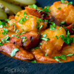 Close up Hungarian paprikas krumpli or paprika potatoes stew with pickles featuring a title overlay.