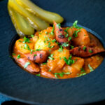 Hungarian paprikas krumpli or paprika potatoes stew with pickles.