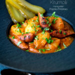 Hungarian paprikas krumpli or paprika potatoes stew with pickles featuring a title overlay.