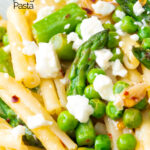 Close up pea and asparagus pasta with casarecce, feta cheese and chilli flakes featuring a title overlay.