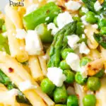 Close up pea and asparagus pasta with casarecce, feta cheese and chilli flakes featuring a title overlay.