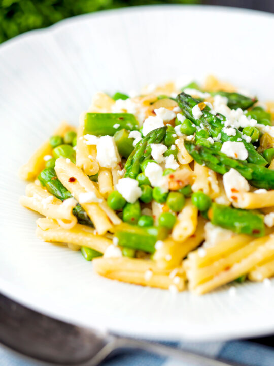 Pea and asparagus pasta with casarecce, feta cheese and chilli flakes.