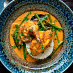 Overhead pheasant curry with coconut milk, green beans and rice.