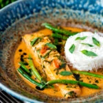 Red Thai salmon curry with green beans and jasmine rice.
