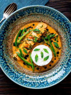 Overhead red Thai salmon curry with green beans and jasmine rice.