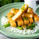 Tofu katsu curry with a homemade sauce, rice and soy roasted tenderstem broccoli featuring a title overlay.