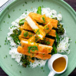 Overhead tofu katsu curry with a homemade sauce, rice and soy roasted tenderstem broccoli featuring a title overlay.