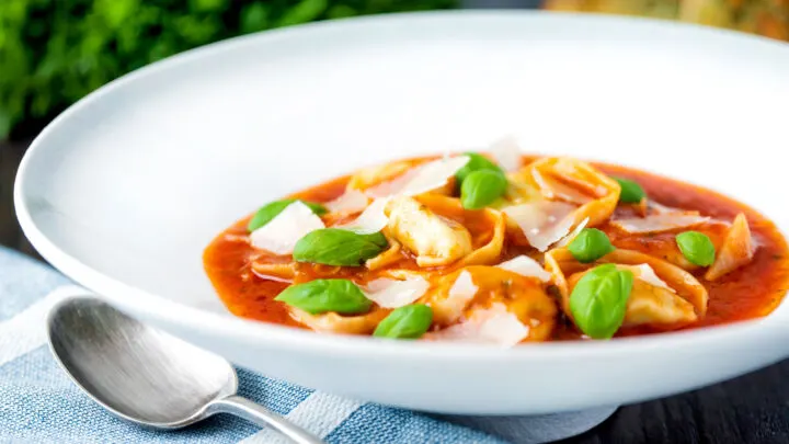 Quick and easy tortellini soup with tomato, fresh basil and parmesan shavings.