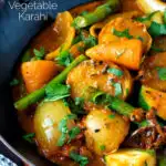 Close up vegan mixed vegetable karahi curry served in an iron kadai featuring a title overlay.