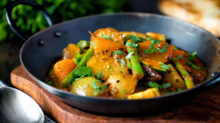 Indian vegan mixed vegetable karahi curry served in an iron kadai.
