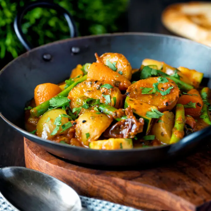 Indian vegan mixed vegetable karahi curry served in an iron kadai.