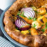 Close up roasted vegetable toad in the hole.