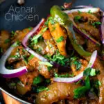 Close up achari chicken or chicken pickle served in a kadai with a chapati featuring a title overlay.