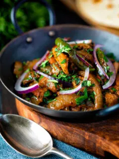 Achari chicken or chicken pickle served in a kadai with a chapati.