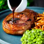 Port lamb sauce being poured over a pan fried Barnsley chop featuring a title overlay.