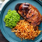 Over head pan fried Barnsley chop with port lamb sauce, straw potatoes and minted peas.