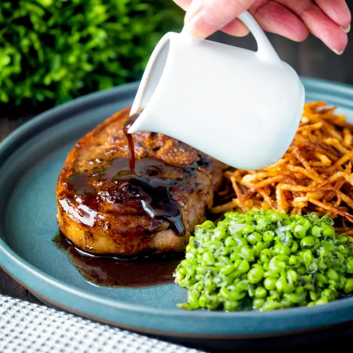 Port lamb gravy poured over a pan fried Barnsley chop with straw potatoes and crushed peas.