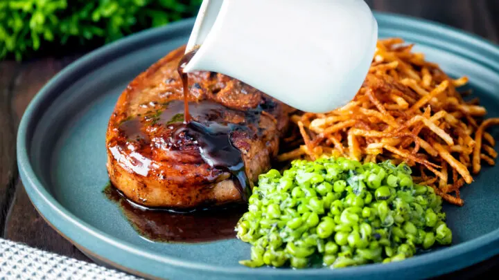 Port lamb gravy poured over a pan fried Barnsley chop with straw potatoes and crushed peas.