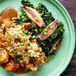 Overhead braised cavolo nero with peas and shallots served with veggie crumble featuring a title overlay.