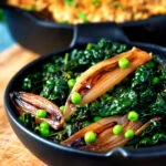 Braised cavolo nero with peas and shallots served with veggie crumble.
