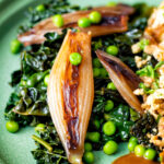 Braised cavolo nero with peas and shallots.