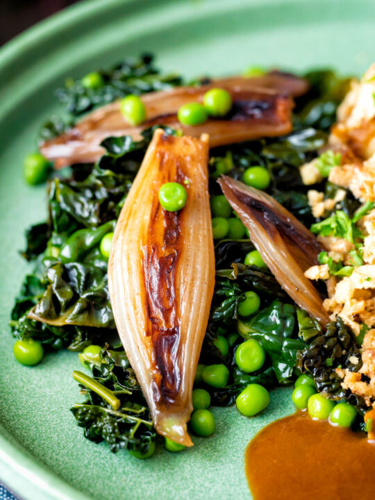 Braised cavolo nero with peas and shallots.