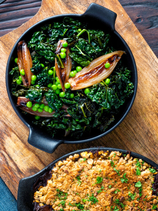 Overhead Braised cavolo nero with peas and shallots.