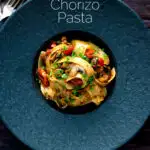 Overhead chorizo pasta with pappardelle, tomatoes and mushrooms featuring a title overlay.