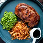 Crushed minted peas served with straw potatoes and a lamb Barnsley chop.