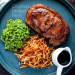 Crushed minted peas served with straw potatoes and a lamb Barnsley chop featuring a title overlay.