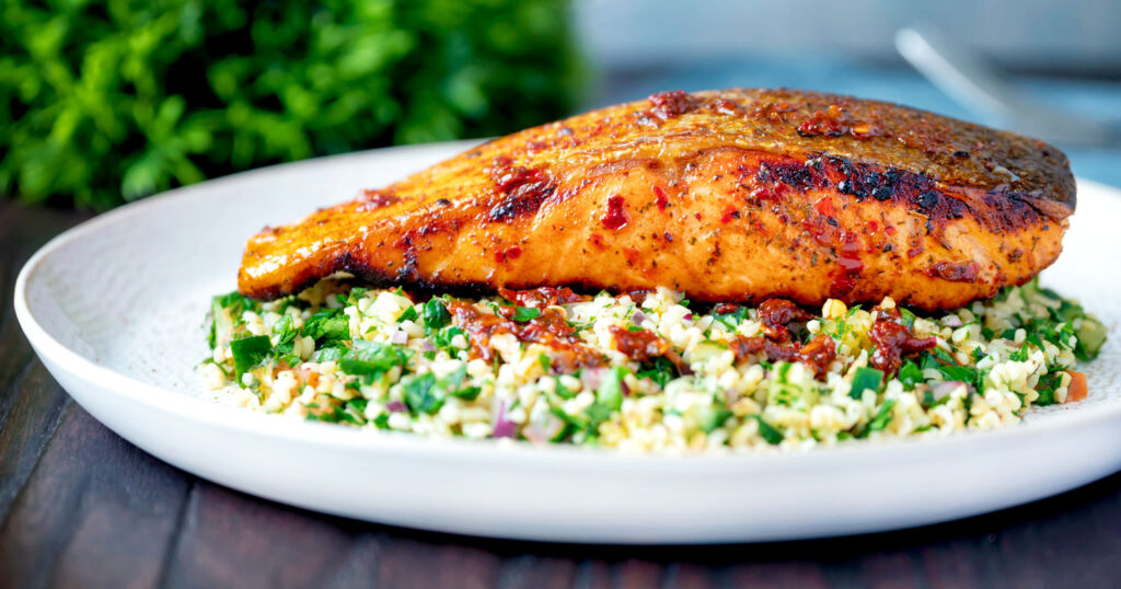 Crispy skinned pan fried harissa salmon fillet served with herby tabbouleh salad.