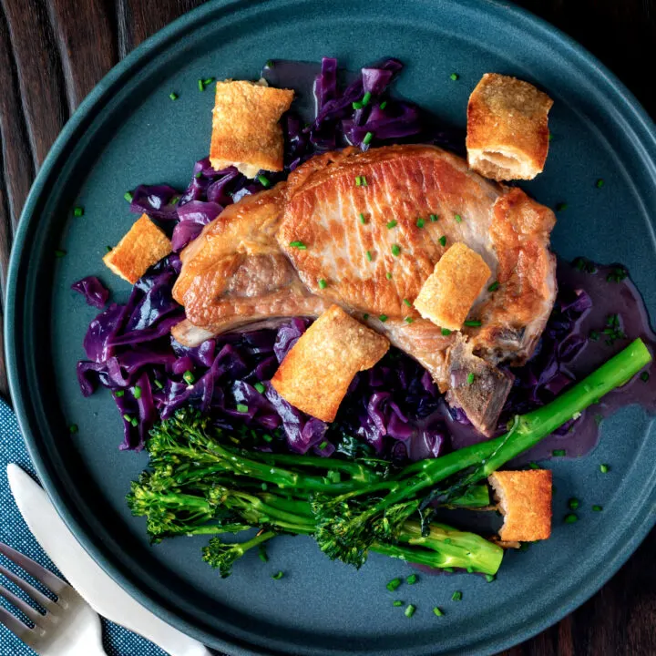 Instant Pot pork chops with red cabbage, crispy crackling and roasted tenderstem brocolli.