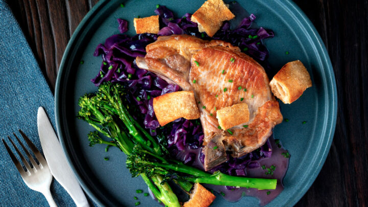 Instant Pot pork chops with red cabbage, crispy crackling and roasted tenderstem brocolli.