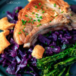 Close up Instant Pot pork chops with red cabbage, crispy crackling and broccoli featuring a title overlay.