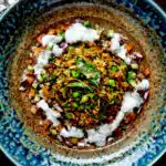 Overhead keema rice served with kachumber salad and mint raita.