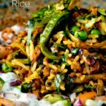 Close up keema rice served with kachumber salad and mint raita featuring a title overlay.